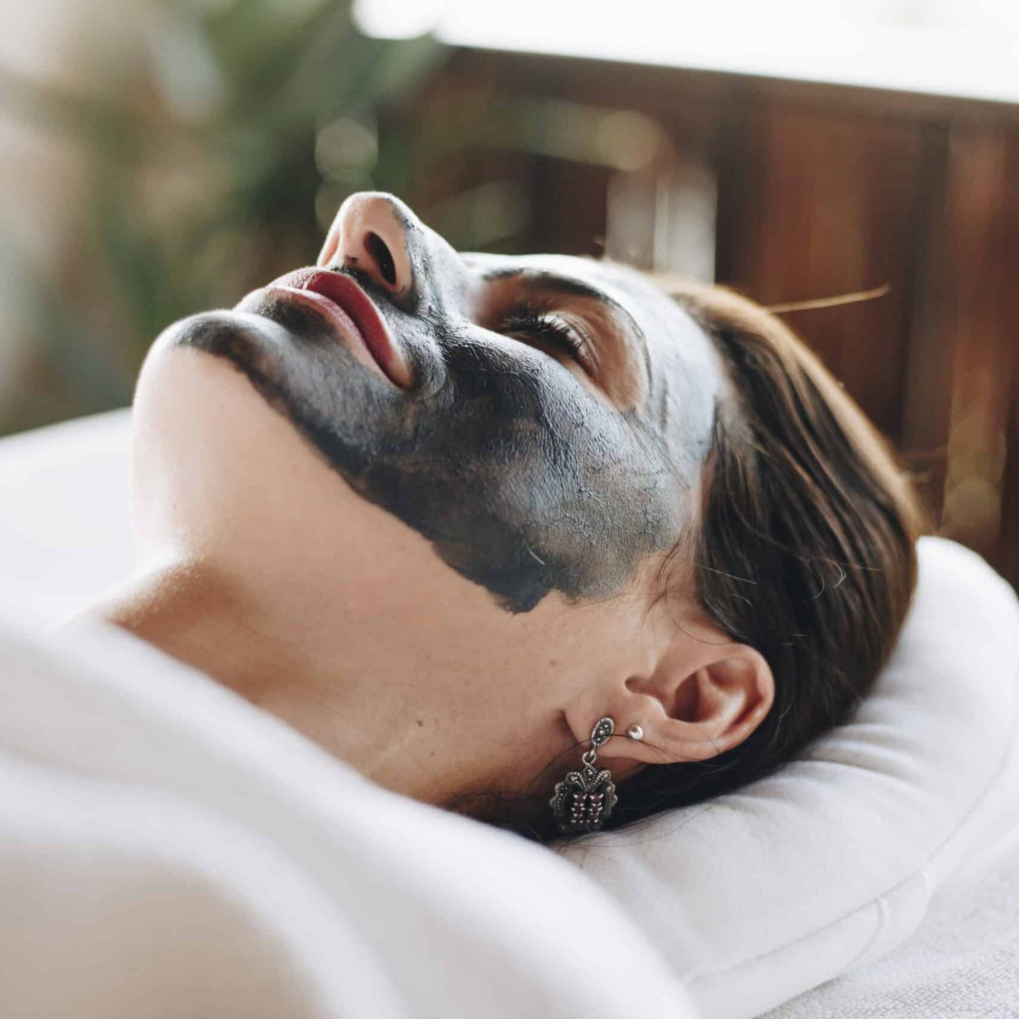 Woman relaxing with a facial mask at the spa